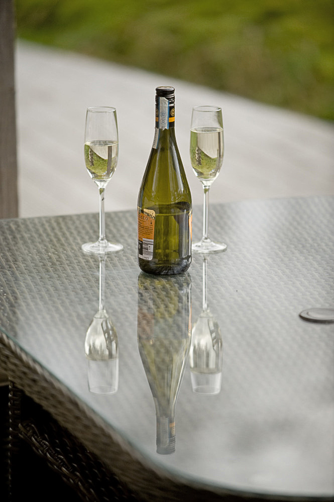 2 glasses and bottle of Prosecco on veranda table, Sithean - environmentally sensitively constructed, high quality Self-catering holiday accommodation. Glen Lonan, Taynuilt, near Oban, Argyll, Scottish highlands, Scotland 

C180507NF5D0200-10S0