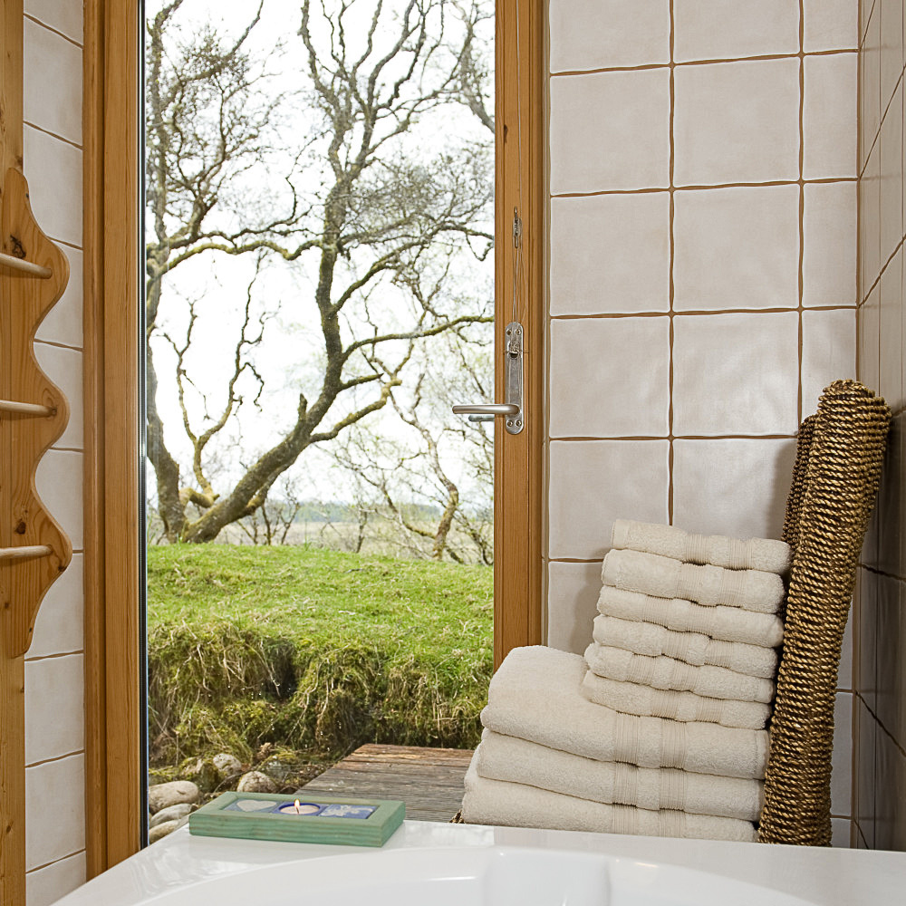 Secluded view from bath through french window to birch woodland, Sithean - environmentally sensitively constructed, high quality Self-catering holiday accommodation. Glen Lonan, Taynuilt, near Oban, Argyll, Scottish highlands, Scotland 

C180507NF5D0164-1CS0